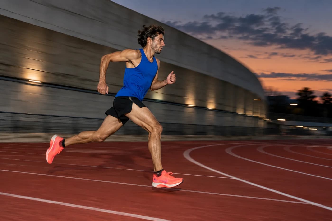 Runner in motion on an athletics track